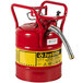 A red Justrite steel safety can for gas with a metal hose.