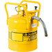A yellow metal cylinder with a hose attached.
