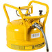 A yellow Justrite safety can with a metal hose attached.