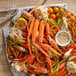 A plate of Snow Crab clusters with carrots and dip.