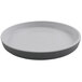 A white round plate with a black rim on a white background.