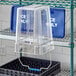 A clear plastic container with a clear cover on a shelf.
