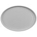 A white oval platter with a circular pattern on the surface.