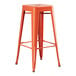 An orange metal barstool with a seat.