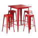 A Lancaster Table & Seating ruby red metal bar table with four backless stools.