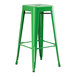 A Lancaster Table & Seating jade green metal barstool with a black seat.