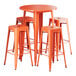 A Lancaster Table & Seating bar height table with four orange metal backless barstools.