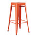 An orange metal barstool with a wooden seat.