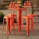 Lancaster Table & Seating bar height outdoor table with orange barstools.