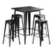 A black Lancaster Table & Seating Alloy Series bar height table with four black backless stools.
