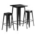 A Lancaster Table & Seating black metal bar height table with 2 black stools.