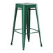 An emerald green metal Lancaster Table & Seating bar stool with legs and a seat.