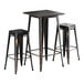 A Lancaster Table & Seating distressed copper outdoor table with black metal legs and two backless barstools.