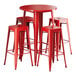 A Lancaster Table & Seating red metal bar table with four red backless barstools.