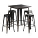 A black Lancaster Table & Seating outdoor table with four black backless barstools.