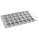 A silver Baker's Mark mini bread pan with 28 square compartments.
