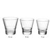 An Acopa Select clear flared rocks glass with a short rim on a white background.