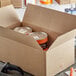 A cardboard box with cans in it.