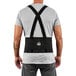 A man wearing a black Ergodyne back support belt with elastic straps.