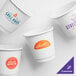 A customizable white paper hot cup with a blue logo.