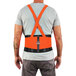 A person wearing an Ergodyne ProFlex Hi-Vis Back Support Brace over a safety vest.