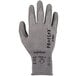 A close-up of an extra large Ergodyne ProFlex warehouse glove with a grey HPPE polyester/spandex shell and black polyurethane palm coating.