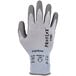 A close-up of a white and grey Ergodyne ProFlex glove with Polyurethane palm coating.