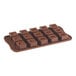 A brown silicone chocolate mold with 15 square compartments.