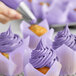 A close-up of a cupcake with Chefmaster violet frosting.