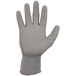 A close-up of a gray Ergodyne ProFlex warehouse glove with a white palm coating.