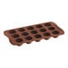 A brown silicone chocolate mold with 15 round compartments.