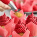 A close-up of a red Chefmaster cupcake.