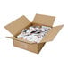A cardboard box filled with small white packets of crushed red pepper.