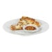 A slice of pizza with a bowl of Crushed Red Pepper packets.