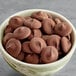 A bowl of Ghirardelli dark chocolate wafers.