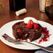 A dessert plate with Ghirardelli dark chocolate and raspberries.