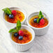 Three white ramekins filled with fruit on top of Rich's Premium Custard Base.