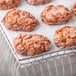 A metal tray with four Rich's glazed apple fritter donuts.