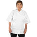 A woman wearing a white Uncommon Chef short sleeve chef coat.