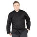 A man wearing a black Uncommon Chef long sleeve chef coat with a mesh back.