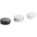 A group of black round metal tins with push & pop covers.