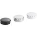 A group of white round metal tins with push and pop covers.