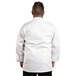 A man wearing a white Uncommon Chef long sleeve chef coat.