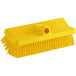 A Carlisle yellow floor scrub brush with a handle.