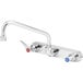 A chrome T&S wall mount faucet with blue lever handles.