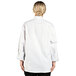 A woman wearing a white Uncommon Chef long sleeve chef coat.