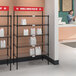 A black NSF shelving unit with white bags on the shelves.