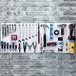 A white Triton DuraBoard with various tools on hooks.