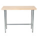 An Advance Tabco wood work table with a galvanized metal base.