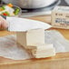 A person cutting Melt Organic unsalted butter on a cutting board.